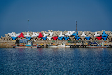 fishing boats moored in a pretty little harbor