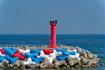 a beautifully colored harbor and red lighthouse