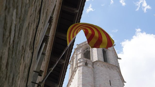Тhe catalan flag is blowing in a light wind against a blue sky