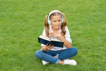 teen girl lifestyle. tween dislike the book. relax in park. music education while listening....