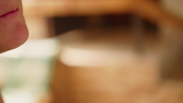 Close up of woman putting a piece of cake on a fork in her mouth 50fps