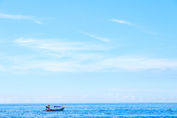 sawarna beach,a view of the beautiful, blue sea sky and fishermen sailing. 