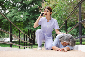 Senior adult women suffering heart attack and worried nurse making emergency call. 