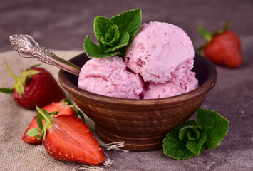 Homemade strawberry ice cream in a clay bowl. Close-up.

