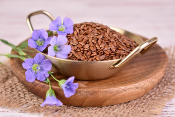 Flax seeds and flax flowers. Useful flax seeds in a bowl.

