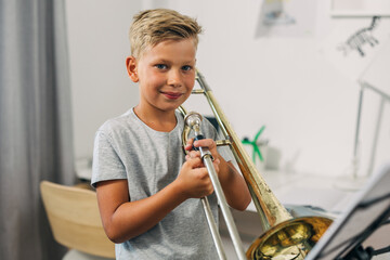 Cute young boy poses with his instrument.