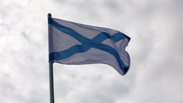 St. Andrew's Flag Fluttering In The Wind Against A Sky Of Clouds