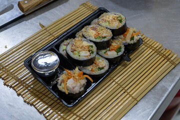 the exquisite art of Japanese cuisine with our expertly crafted sushi, beautifully arranged in a convenient box.