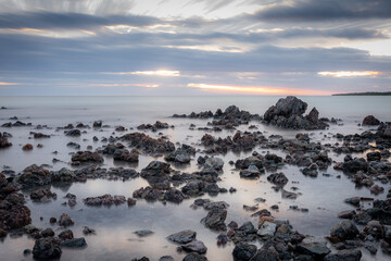Rocks on a beach at sunset