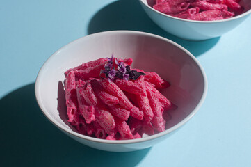 Delicious trendy pink beetroot pasta on minimalist blue background recipe copy space stylish flat lay