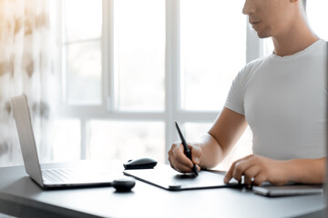 man working on a graphics tablet, space for text