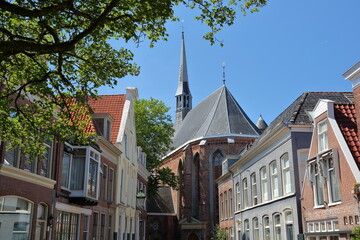 Jacobijnerkerk church viewed from Bij de Put street in Leeuwarden, Friesland, Netherlands, with historic buildings in the foreground