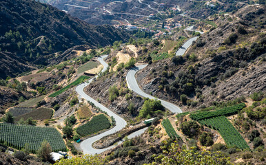High angle view of curvy mountain road with vegetable cultivation fields