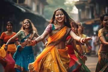 Tuinposter Indian women dancing on the streets in traditional dresses © Denis