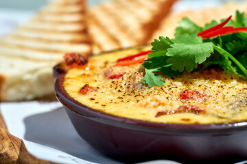 Baked seafood under cheese with mushrooms. Baked shrimp, mussels and salmon in a ceramic pan