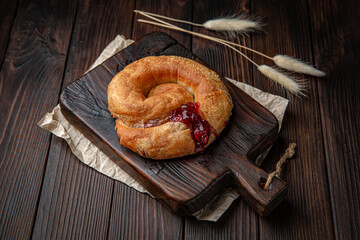 Lush placinda with cherries on brown boards. Bakery products. Fresh bakery.