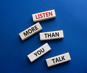 Listening skills symbol. Concept words Listen more than you Talk on wooden blocks. Beautiful deep blue background. Business and Listen more than you Talk concept. Copy space