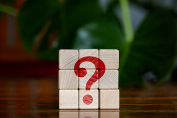 question mark on wooden block for faq, information, problem and solution, test, testing, survey, questioning, support, knowledge, decision, on blurred nature background.
