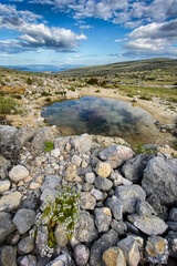 Sunrise on Krk Island. Beautiful sunset by the Adriatic Sea, Mediterranean. Epic mountains, rocks, cliffs, small pond, yellow sand, waves and turquoise water. Premium landscape nature, Baska, Croatia