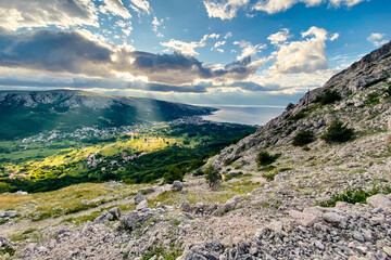 Sunrise on Krk Island. Beautiful sunset by the Adriatic Sea, Mediterranean. Epic mountains, rocks, cliffs, small pond, yellow sand, waves and turquoise water. Premium landscape nature, Baska, Croatia