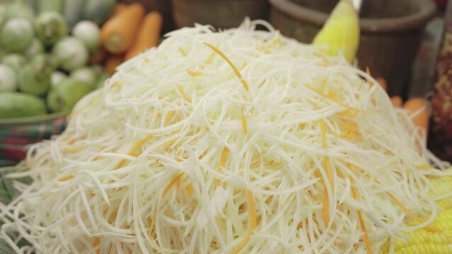 Papaya and carrot were sliced for Som Tum, Thai Papaya Salad, in street food market in Bangkok, Thailand