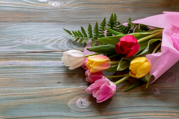 Festive tulips on wooden table close-up
