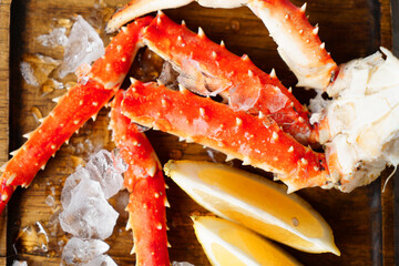Crab meat. on a wooden plate with ice.