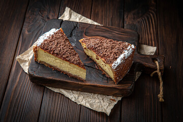 Cheesecake with chocolate chips on brown boards. Bakery products. Fresh bakery.