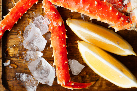 Crab meat. on a wooden plate with ice.