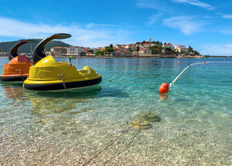 Pleasure boats and catamarans in the parking lot are waiting for tourists.
