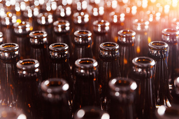 Brewery conveyor with brown glass beer drink alcohol bottles with sun light. Concept modern...