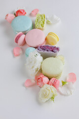Obraz na płótnie Canvas Top view Set Beautiful colorful French macaroons and flowers. Spring Flat lay white background