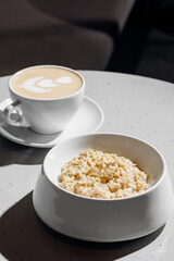 Oatmeal porridge with coffee. Concept healthy breakfast food, modern mood