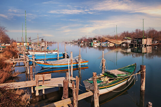 Ravenna, Emilia Romagna, Italy: landscape of the wetland in the Po Delta Park with boats and fishing huts