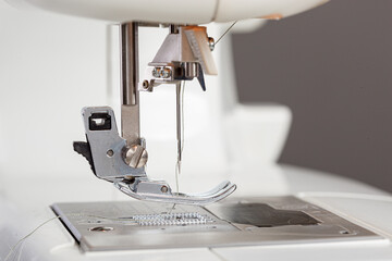 Sewing machine, stitching fabrics, needle in a round plan