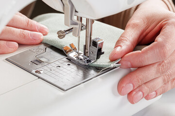 Sewing machine, stitching fabrics, needle in a round plan