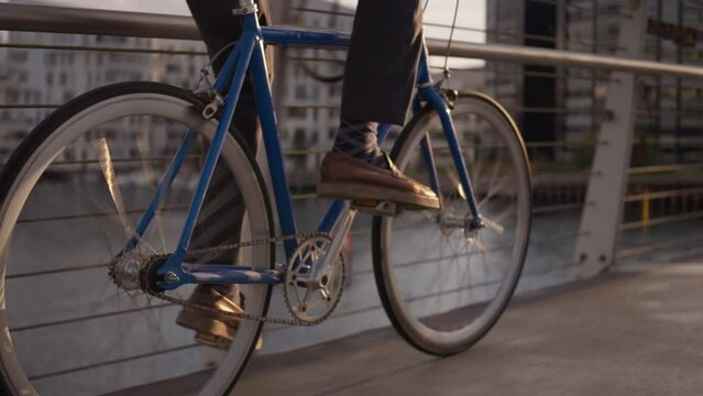 Tracking Shot Of Man As He Pedals Along