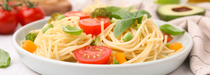 Plate of delicious pasta primavera on white table, closeup. Banner design