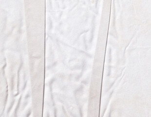Obraz premium Folded and crumpled white cloth texture background. Rippled textile texture backdrop. Creased fabric graphic element.