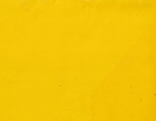 Grunge yellow plastic background template. Smooth and vibrant surface texture.
