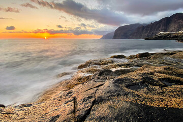 Los Gigantes. Exclusive beach of Tenerife. Beautiful sunset by the Atlantic Ocean. Epic volcanic rocks, cliffs, black sand, waves, turquoise water. Premium landscape from pure nature, Canary Islands 