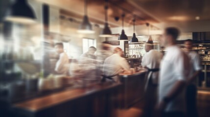 Movement blurred restaurant background with some people eating and chefs and waiters working