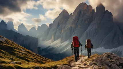 Washable wall murals Dolomites a couple goes hiking in the mountains. beautiful weather with a blue sky and some white clouds. big mountains.