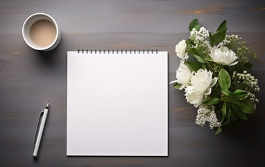 The gray desk with laptop, notepad with blank sheet, pot of flower, stylus and tablet for retouchi