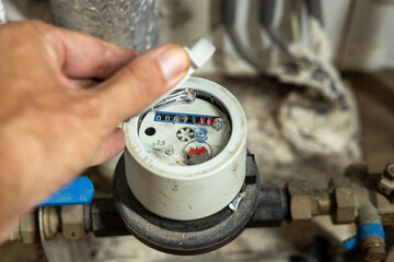 The water meter indicates how much water is consumed at home - obrazy, fototapety, plakaty