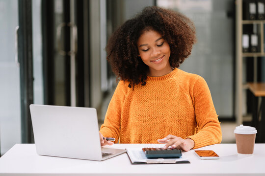 Hand women doing finances and calculate on desk about cost at home office.