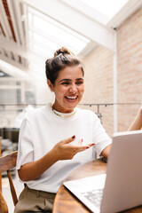 Happy female freelancer speaking during an online meeting