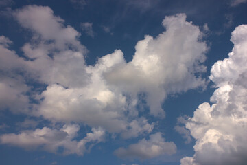 Summer evening sky in the picturesque clouds, lit by the rays of the setting sun.