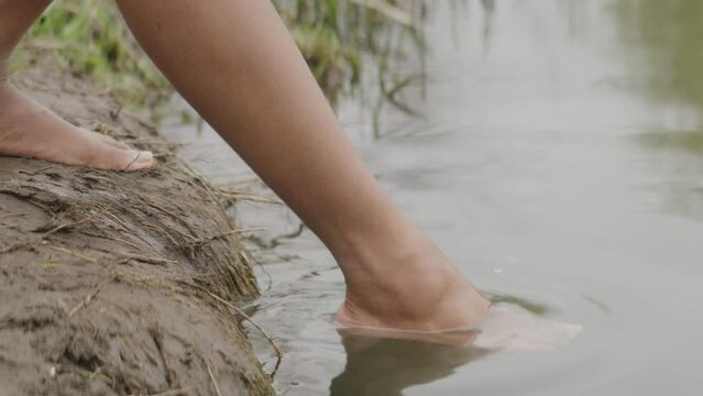 Close up of dipping toes into river