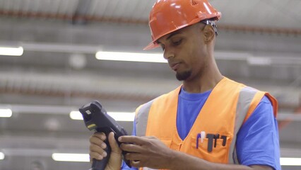 Warehouse employee using handheld barcode reader while doing inventory management. Delivery manager Storehouse scanning goods bar code in industrial storehouse